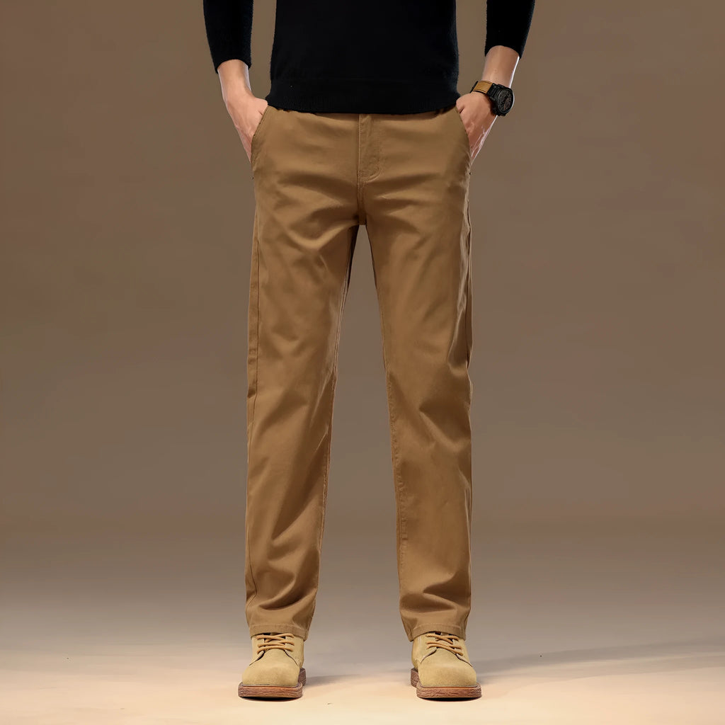Men's cotton denim loose straight casual trousers in rust red with zip fly and elastic waist, front view