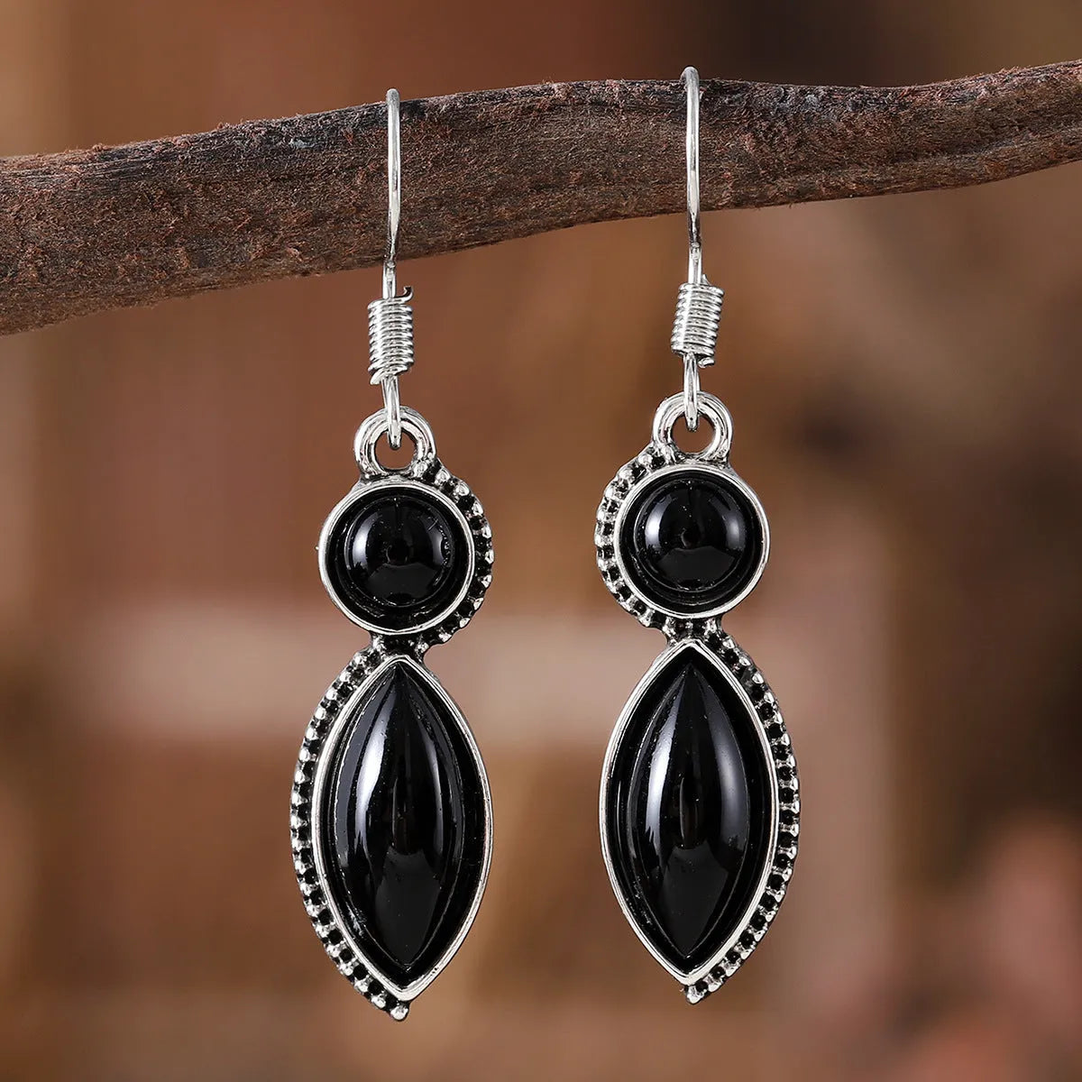 A pair of vintage geometric pendant earrings in black and purple with a round detail, made from zinc alloy.