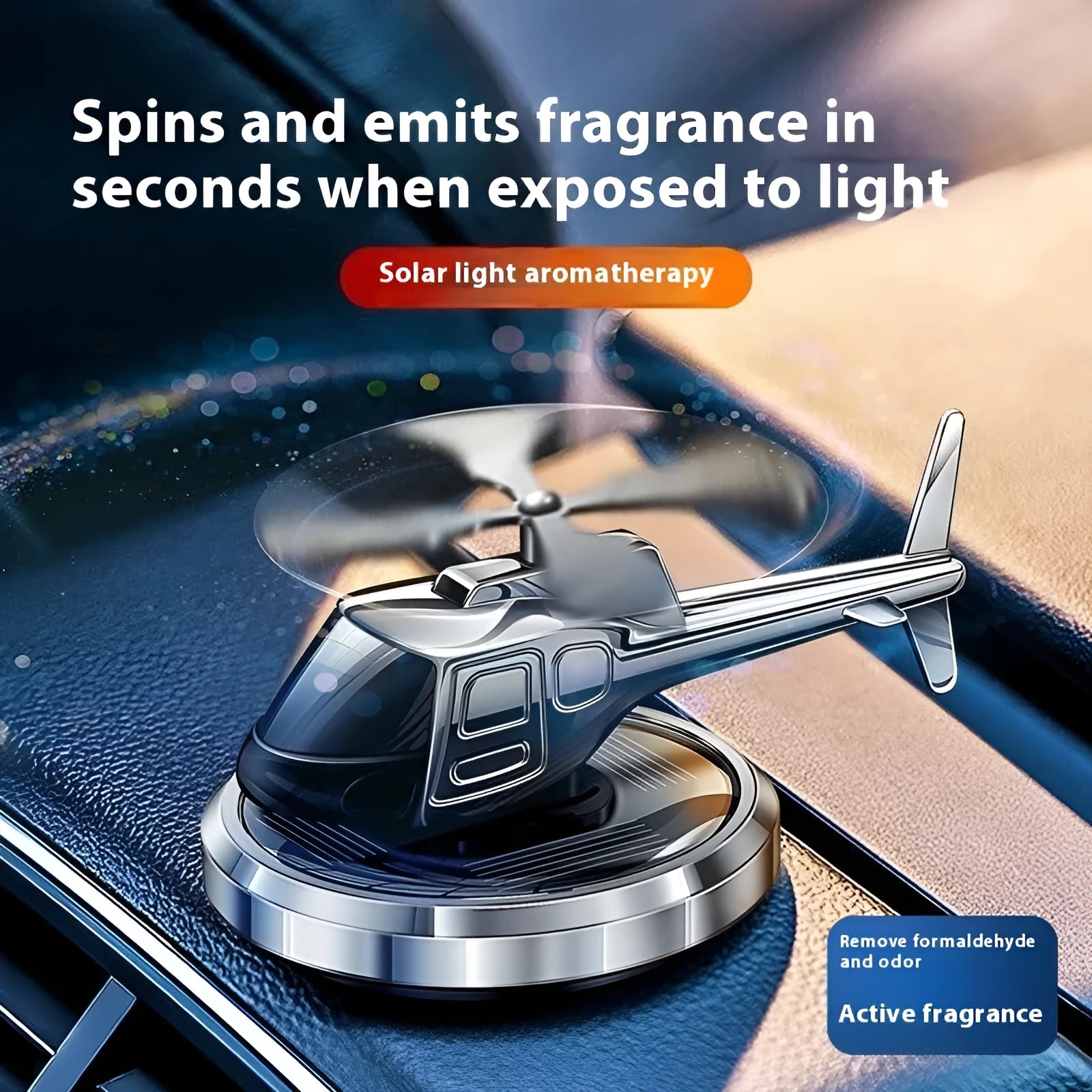 Silver solar-powered metal helicopter car air freshener ornament with spinning blades on a dashboard.