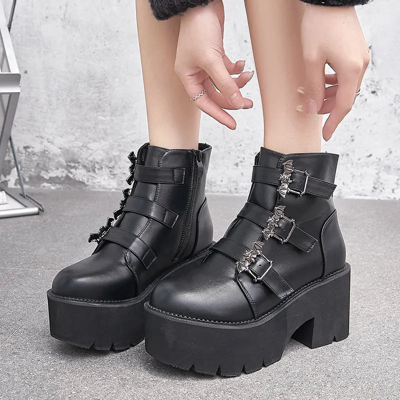 Black women's punk gothic Martin boots with bat buckle detail and side zipper.