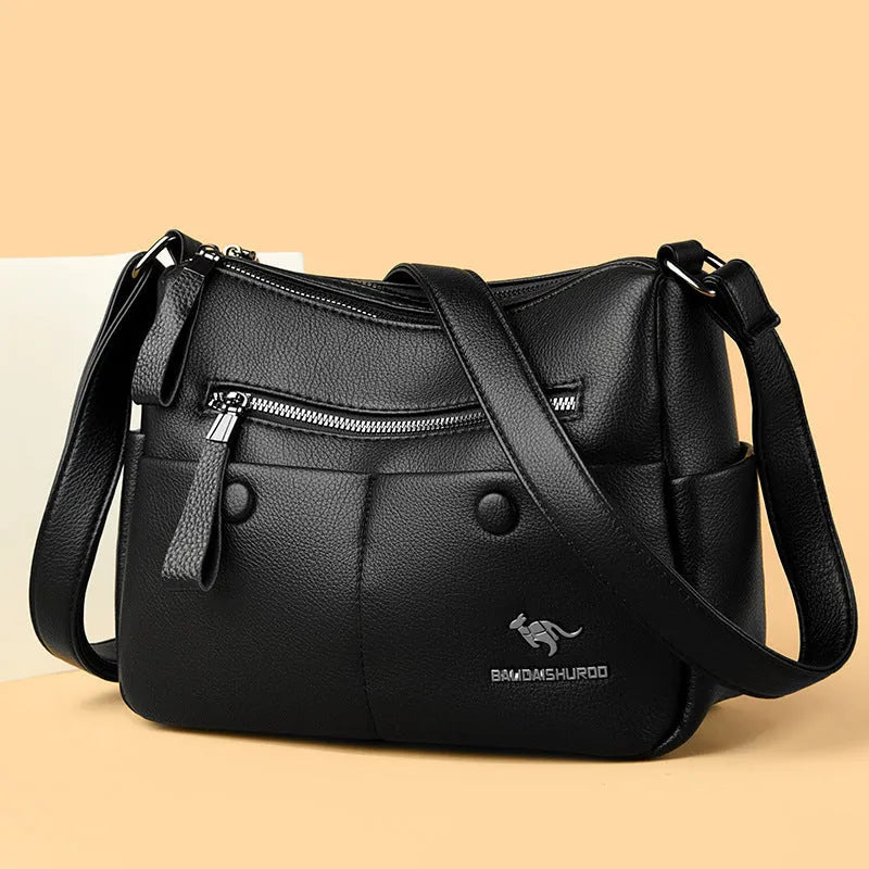 Soft PU leather crossbody shoulder bag in horizontal square shape with stitching details and multiple compartments