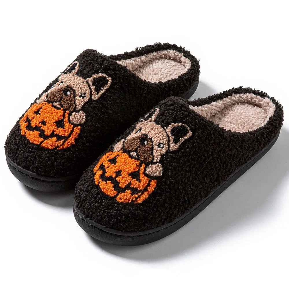 Black Halloween slippers with pumpkin design featuring soft plush upper and non-slip rubber soles.