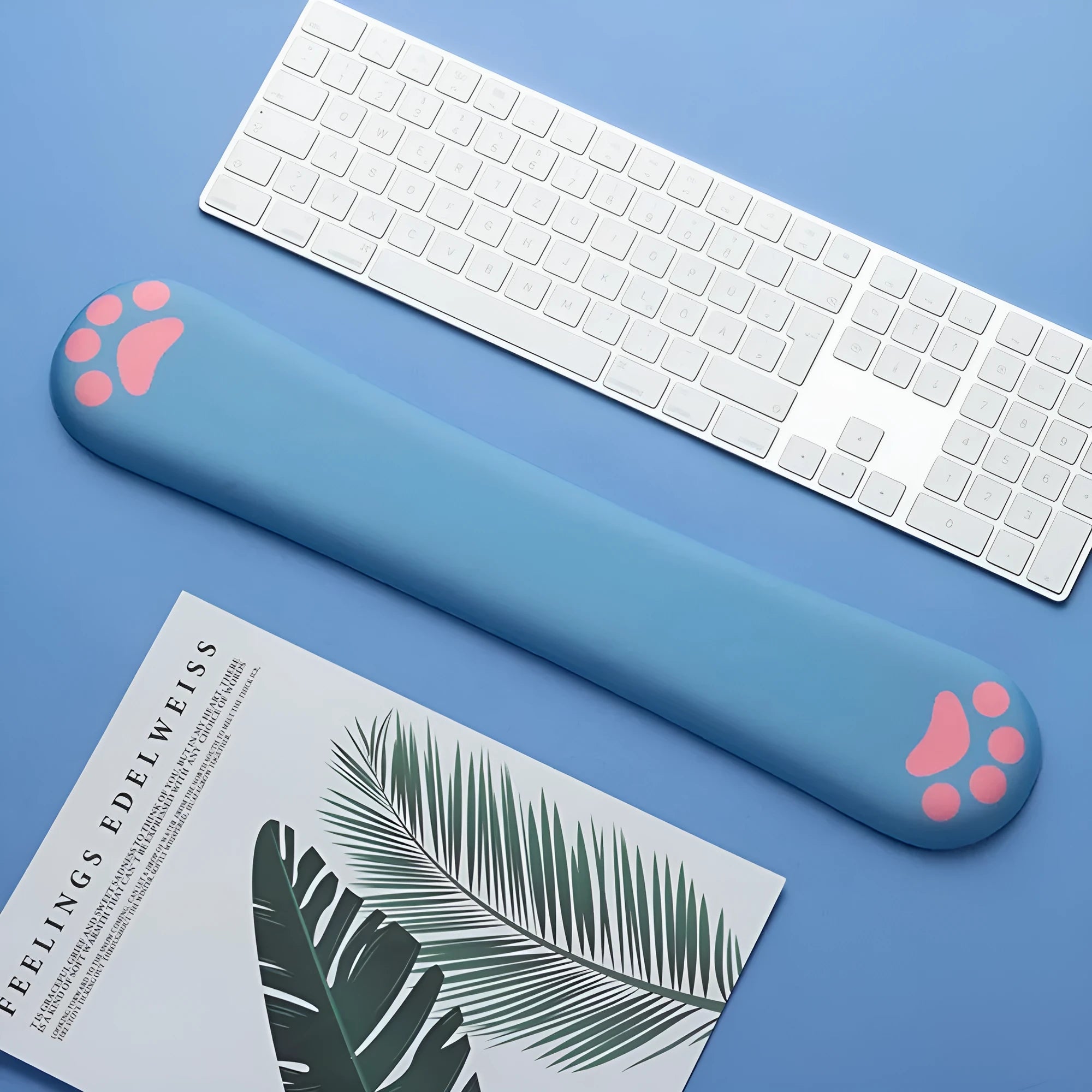 Cat's claw cartoon design memory foam keyboard wrist rest in blue on a desk