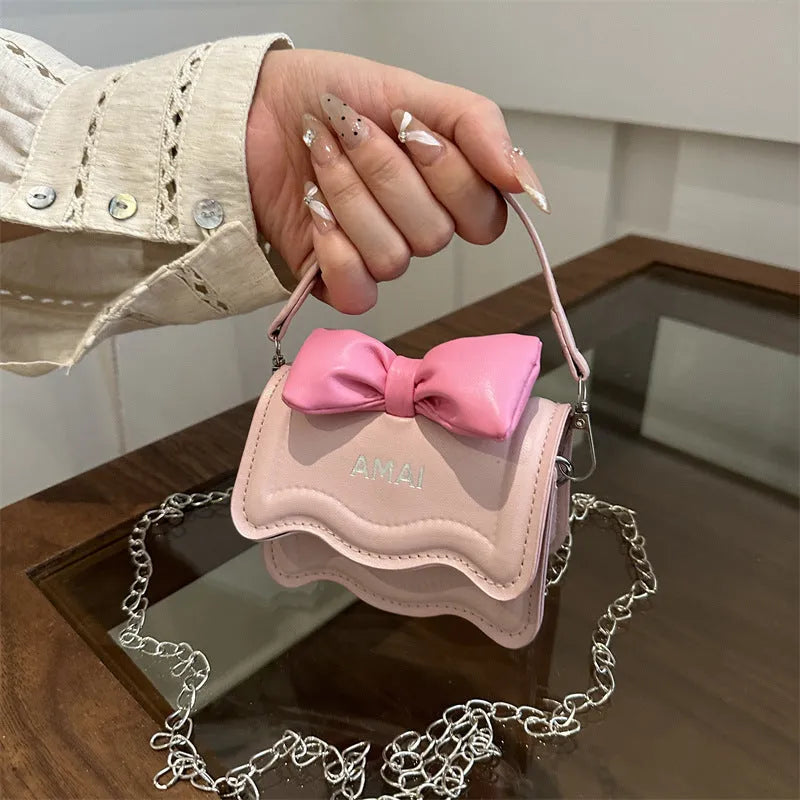 Mini crossbody bag in PU leather with adjustable strap shown in seven colour options