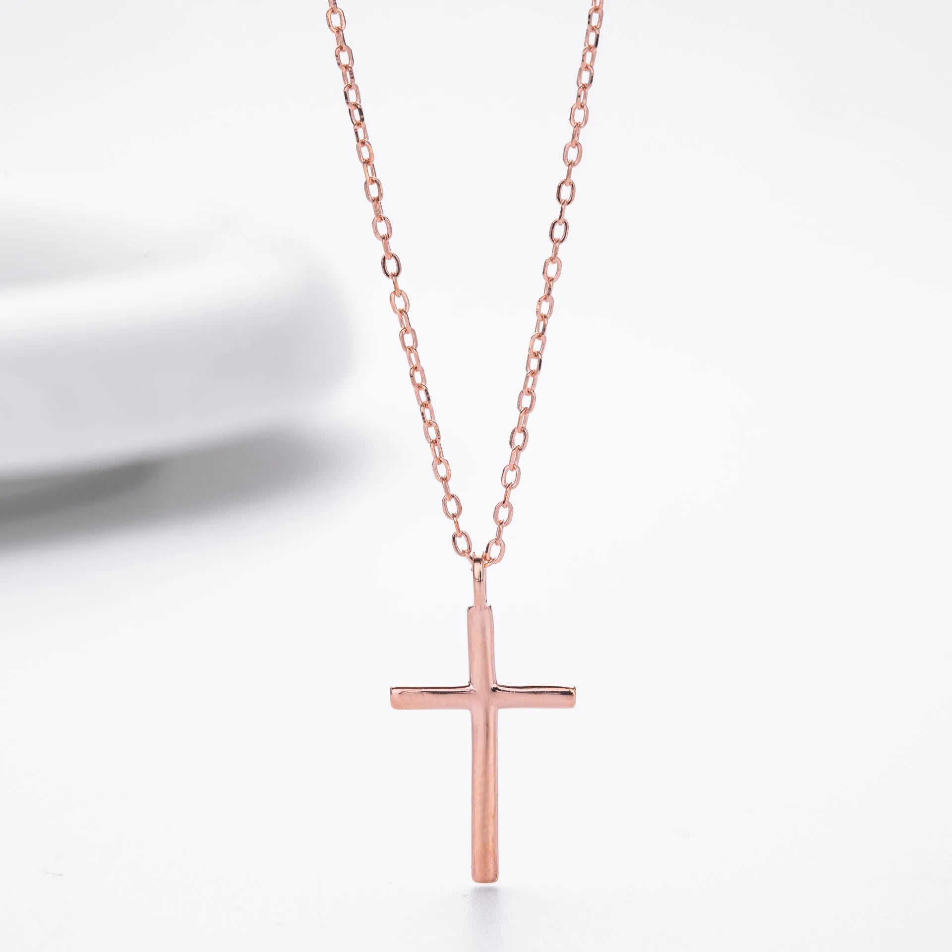 S925 sterling silver necklace with glossy cross pendant on O-chain in gold, platinum, or rose gold plating.