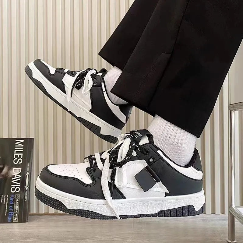 Low-top casual sneakers with synthetic leather upper, stitched detailing, and vulcanised rubber sole in white