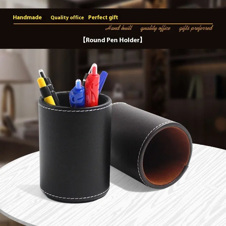 Black leather cylindrical pen holder measuring 8cm wide × 10.8cm tall on desk