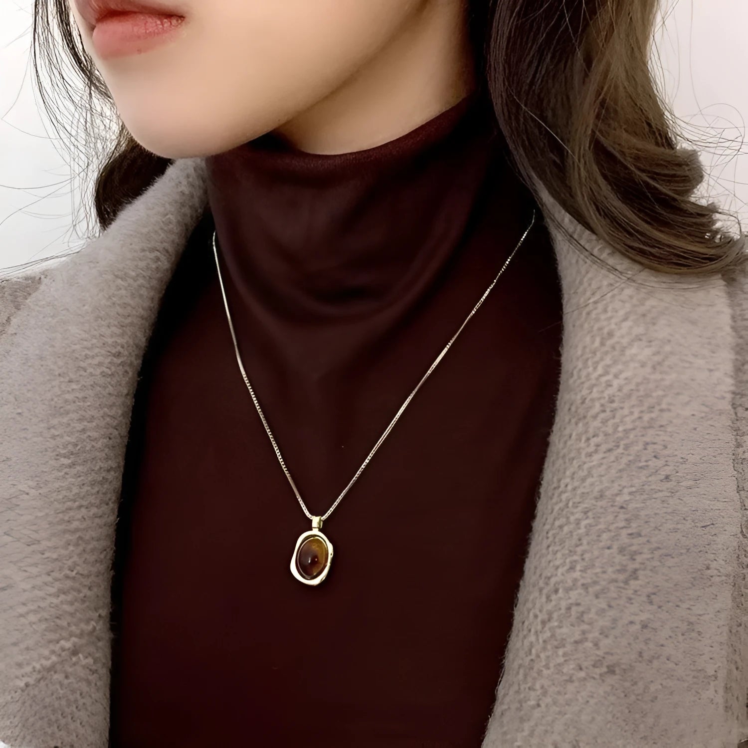 Women's geometric alloy pendant necklace with polished finish and gold copper clavicle chain on neutral background