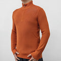 Men's black half-turtleneck zip sweater on a hanger, showing long sleeves and zip front detail.