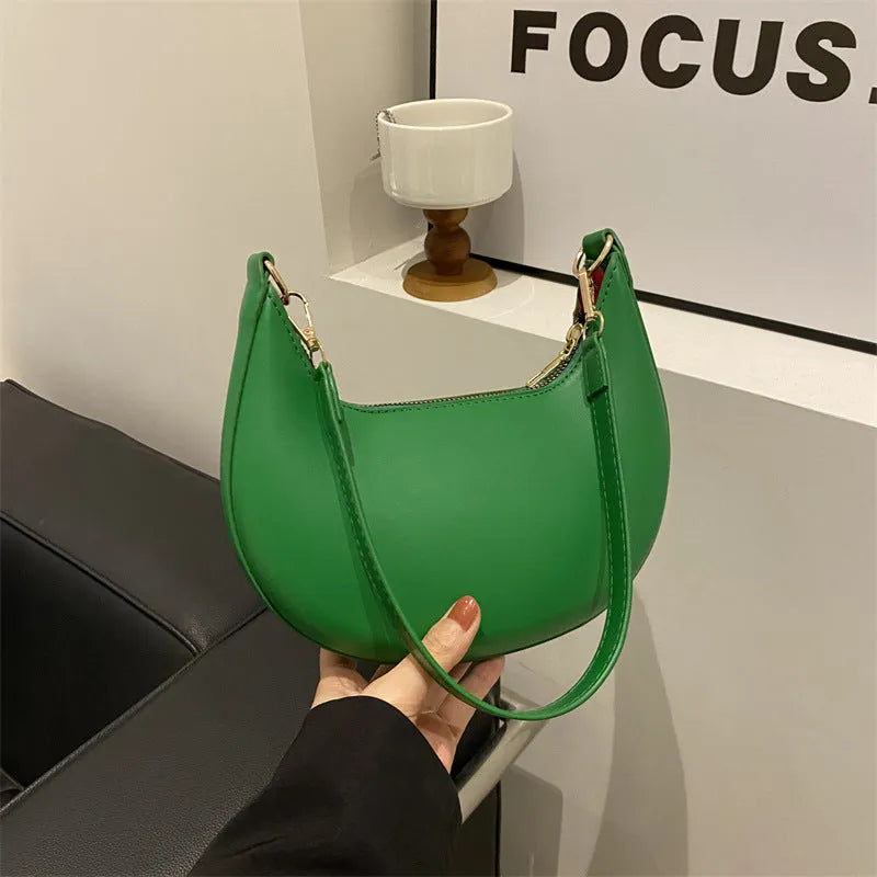 Round green one-shoulder underarm bag showing sewing line detailing and sandwich pocket design