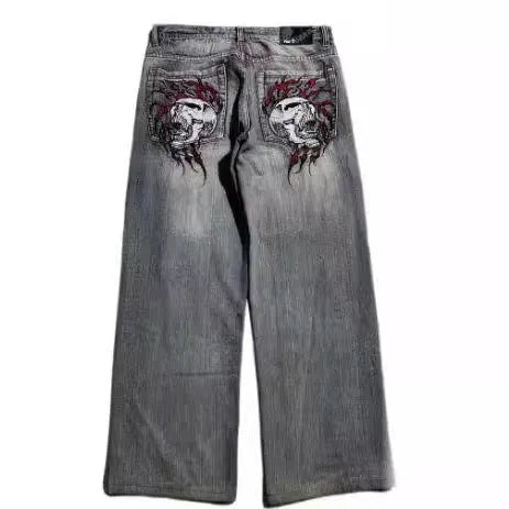 Gray washed-out denim jeans on a man, showing straight wide-leg cut and vintage workwear style.