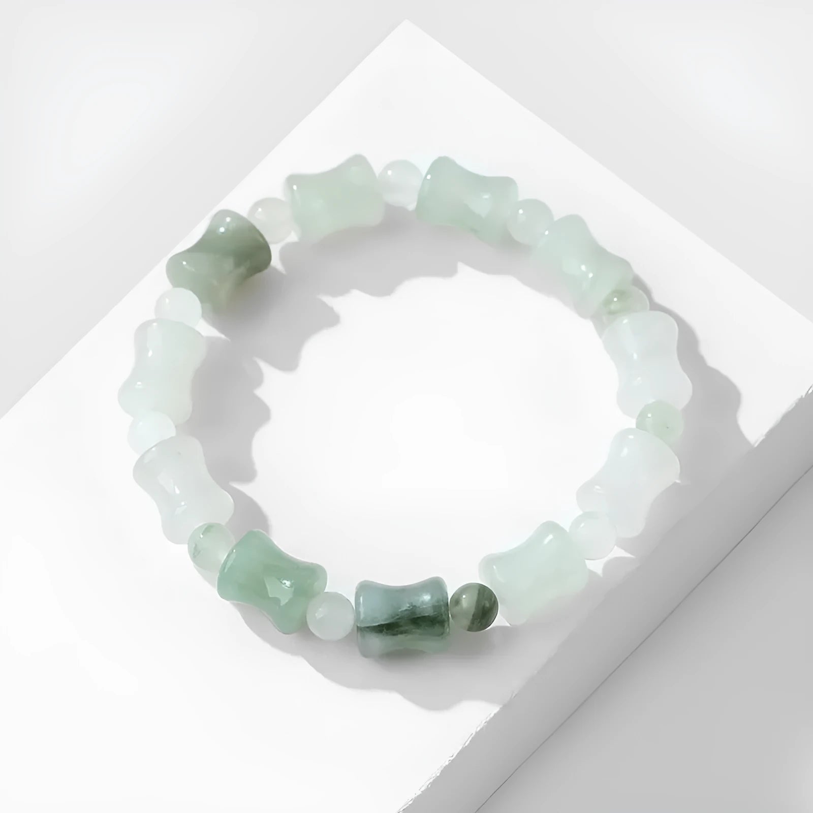 Natural chalcedony beaded bracelet with safety lock closure and diamond-shaped jade beads on elastic string