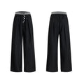 A pair of high-waisted straight-leg casual trousers in a black polyester-cotton blend with a button fly and open hem.
