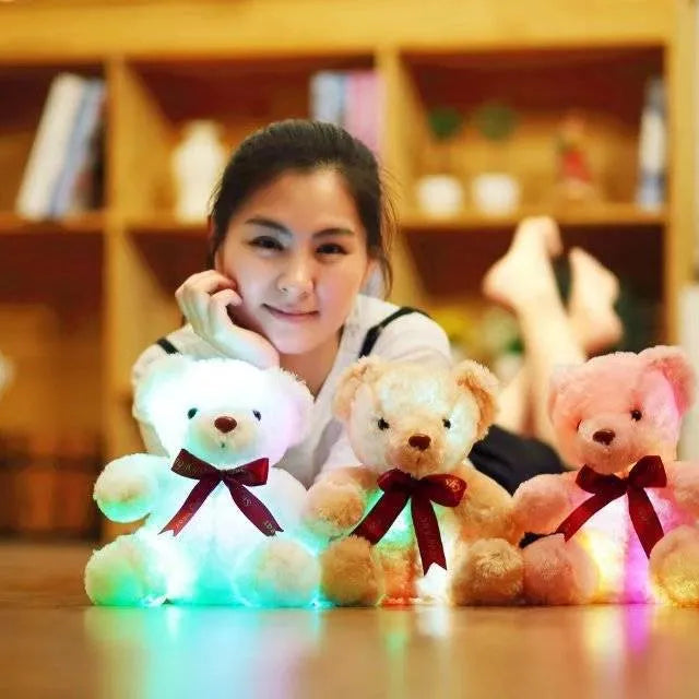 Plush teddy bear with glow feature in brown colour, sitting at 25 cm height