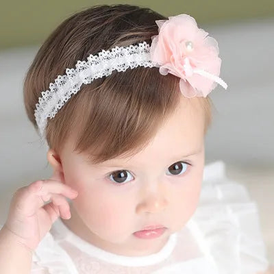 Korean children's fabric flower hairpins in pink and white on display