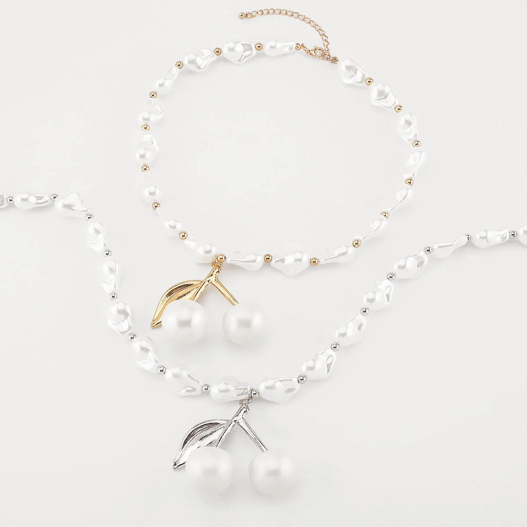 Gold and pearl fruit geometric necklace for women on a white background