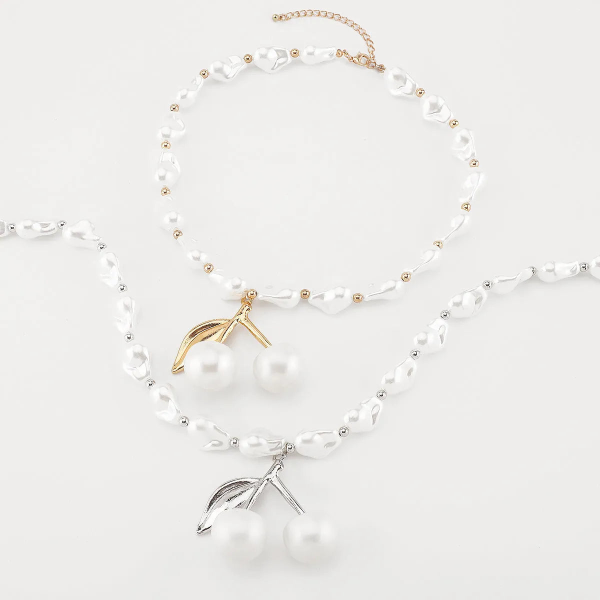 Gold and pearl fruit geometric necklace for women on a white background