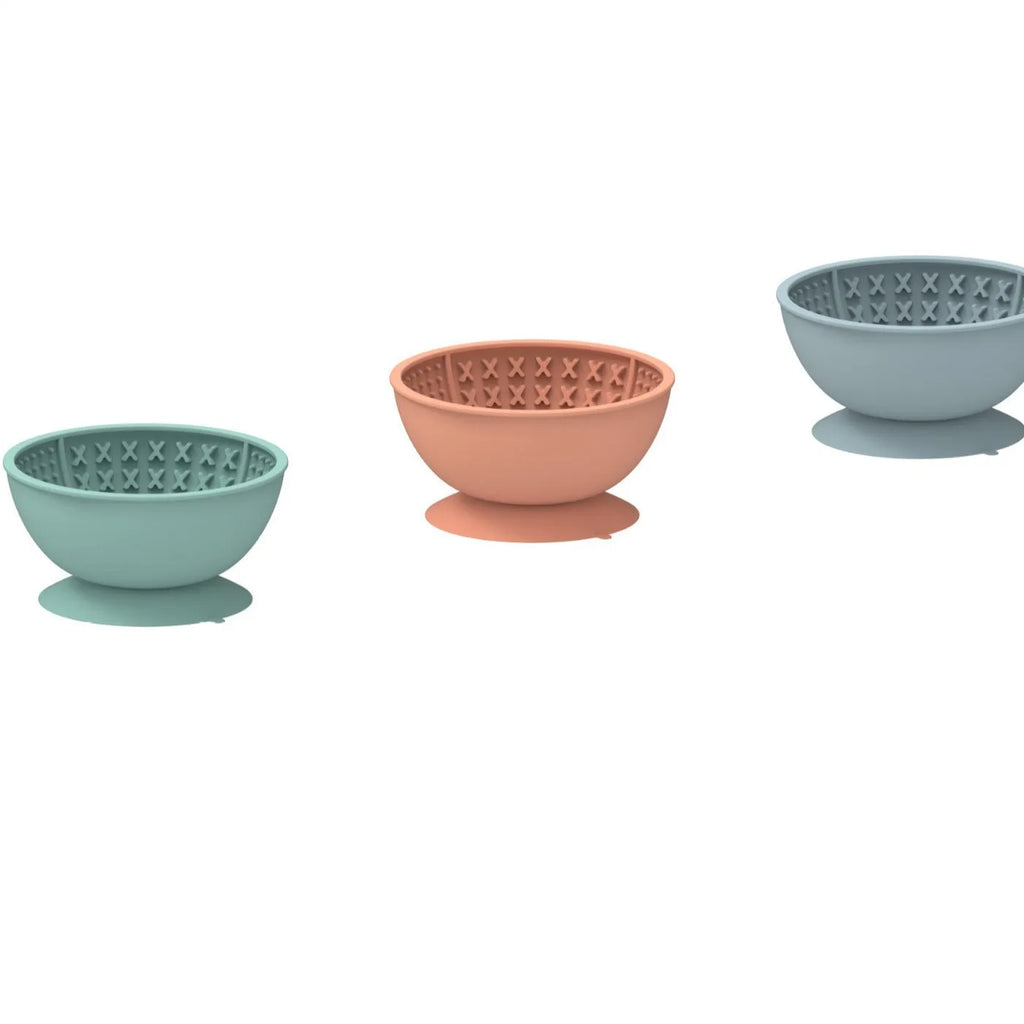 Cyan silicone slow feeding dog bowl with suction cup base showing textured surface