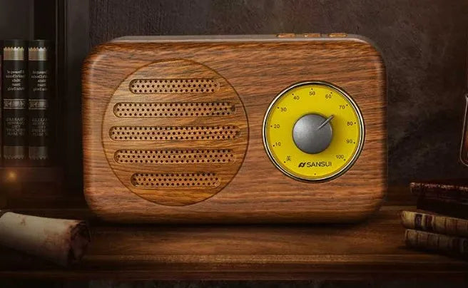 Compact portable Bluetooth speaker in wood colour finish with FM radio and USB cable.