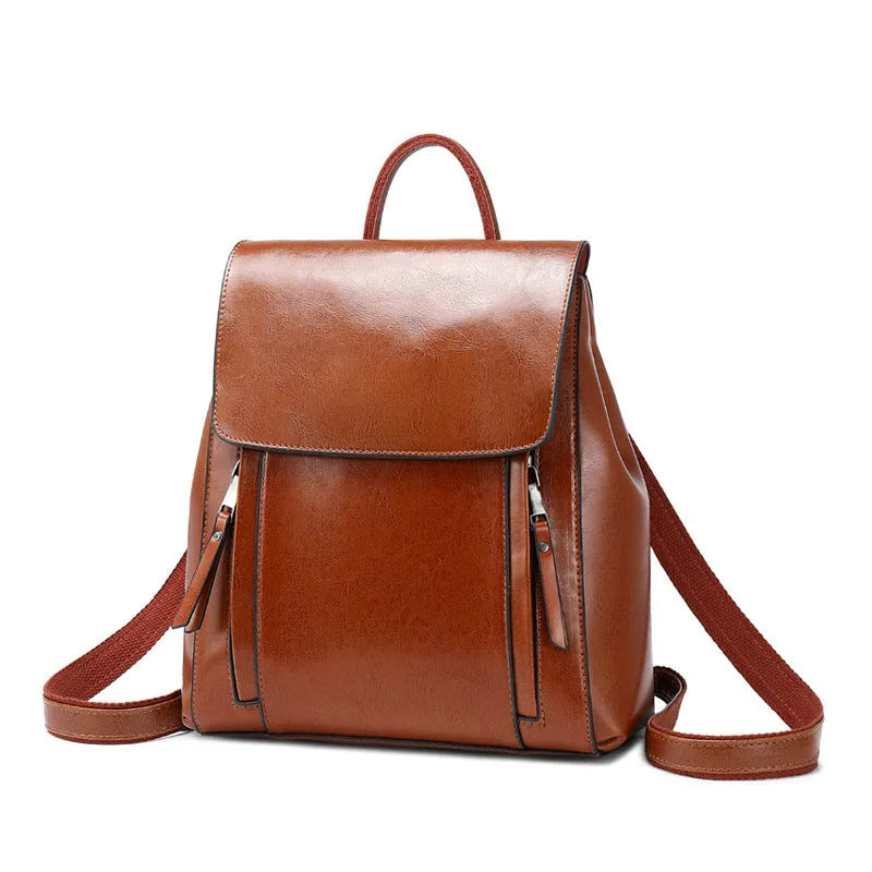 Large black square leather women's backpack with double straps and a cover opening.