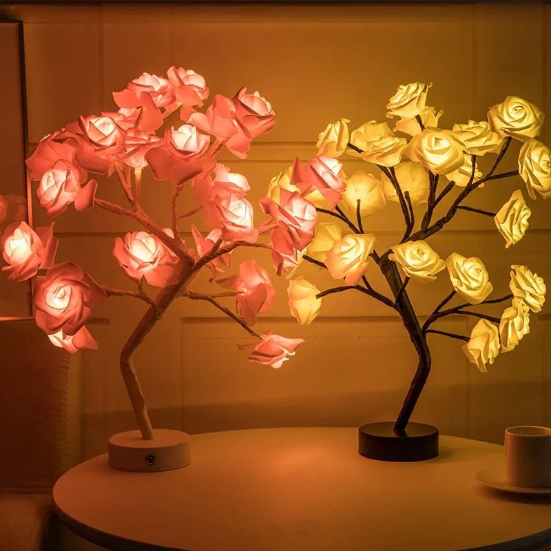 White and red rose flower shaped USB battery LED table lamp with warm white light on a table.