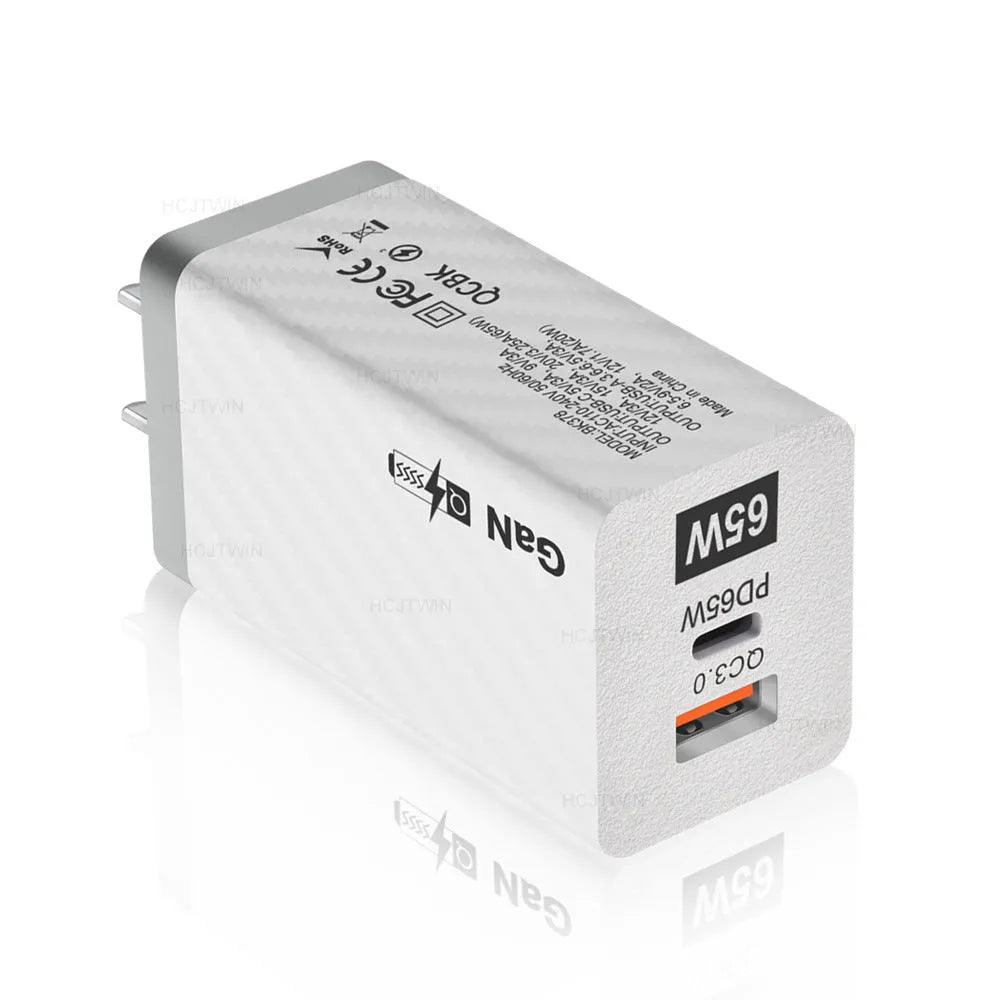 White and black 65W GaN USB-C laptop travel charger with UK, US, and EU plug options