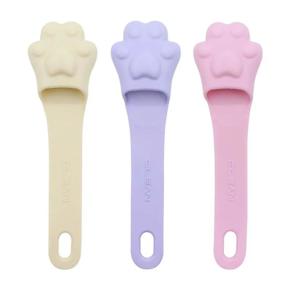 Silicone finger toothbrush for pets in pink, purple and yellow colours