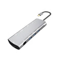 Grey aluminium USB-C docking station showing HDMI, VGA, USB 3.0, and card reader ports.