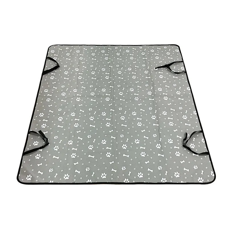 Water resistant dog car seat cover mat on a rear car seat in a bone print pattern.