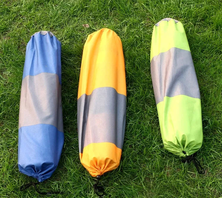 Outdoor automatic inflatable camping mat for one person with memory foam filling, blue and grey colour, shown on grass
