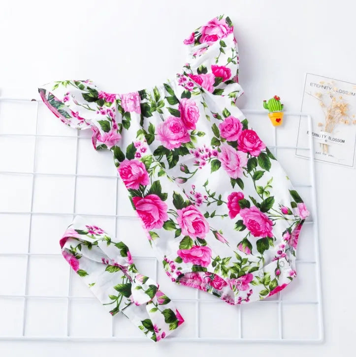 Black and white cotton baby girl romper with small flying sleeves and baby prints