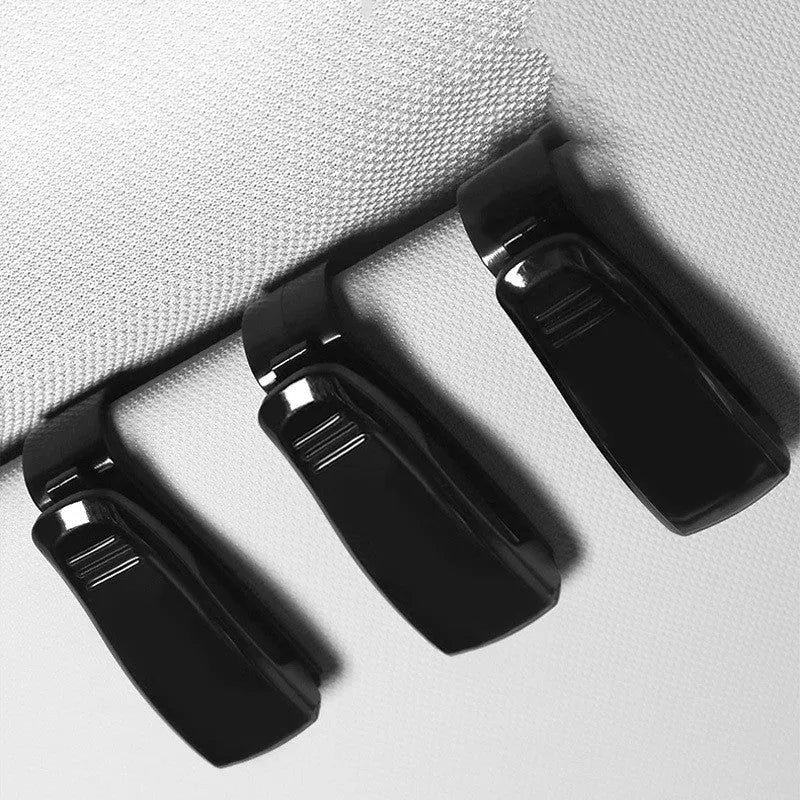 Black plastic car sunshade clip for holding glasses and ID cards, shown next to a ruler showing 6.5cm length.