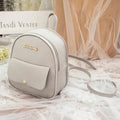 Compact black PU leather women's small backpack with a slim profile and zipper closure.