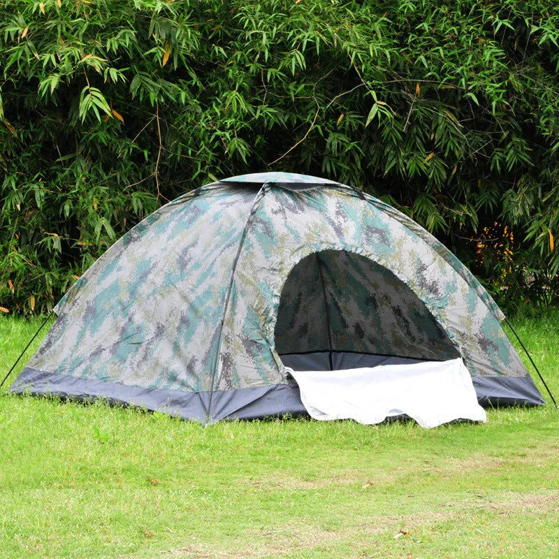 Green camouflage two-person camping tent with triangular skylight and fibre glass poles pitched outdoors.