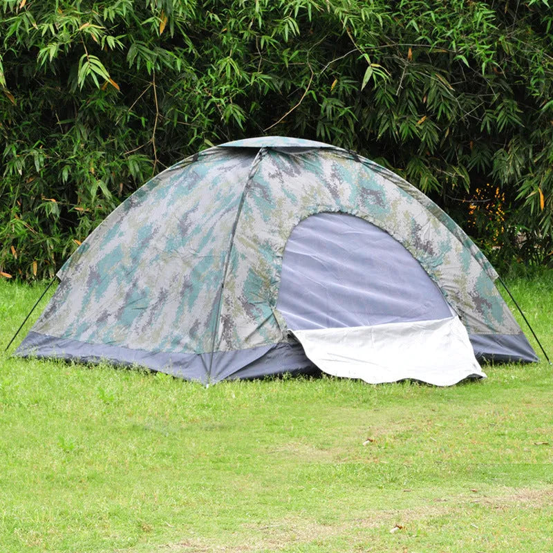 Green camouflage two-person camping tent with triangular skylight and fibre glass poles pitched outdoors.