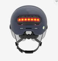 Cycling helmet with built-in LED brake and tail lights on the back, shown in sizes M and L.