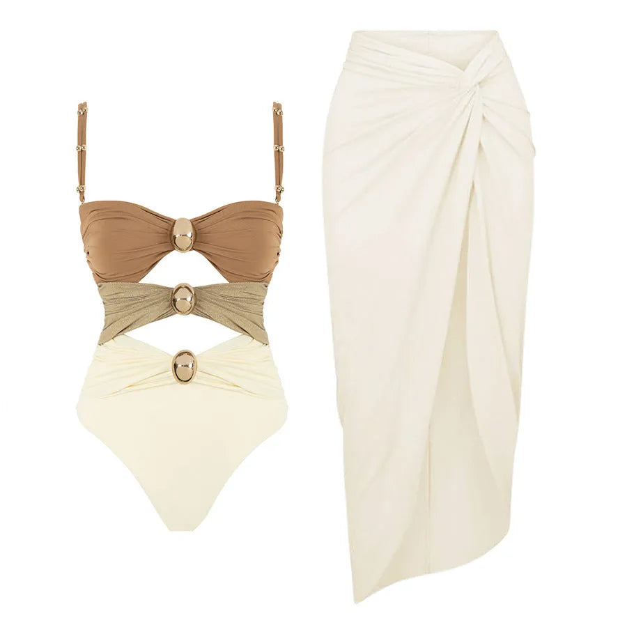 Women's solid colour one-piece swimsuit with detachable skirt and gold button detail.