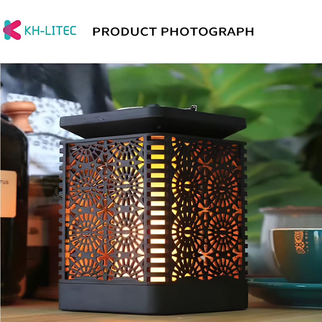 Set of four black solar-powered hanging torch lights with flickering flame LED effect in a garden setting