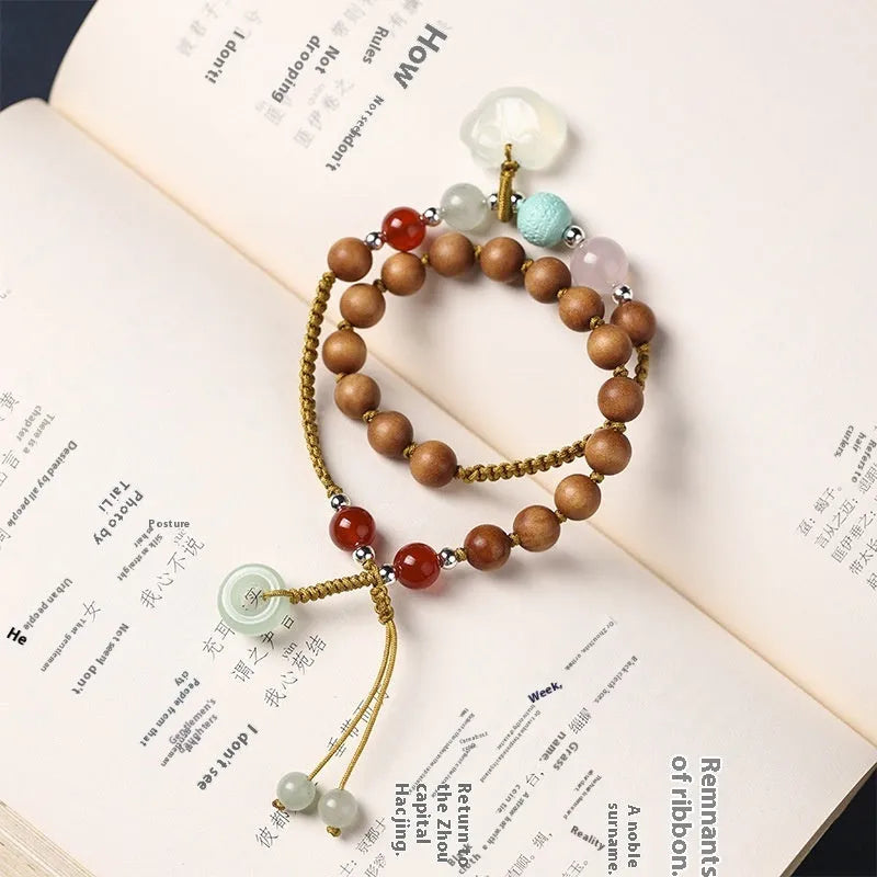Hand-woven ebony wood bracelet with double ring design and traditional Chinese Ruyi elements