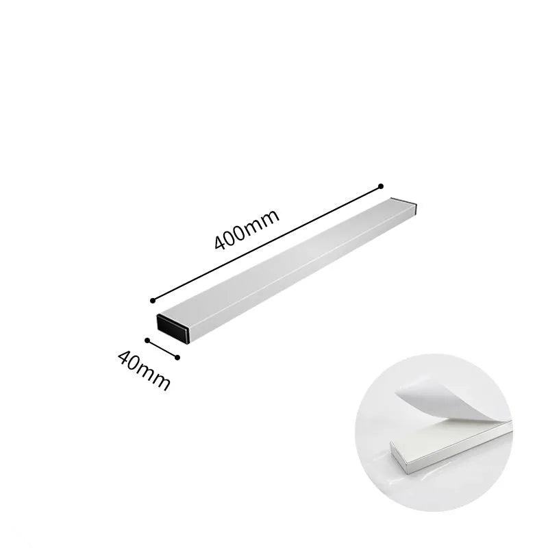 Stainless steel wall-mounted magnetic knife storage rack in various lengths on a kitchen wall.