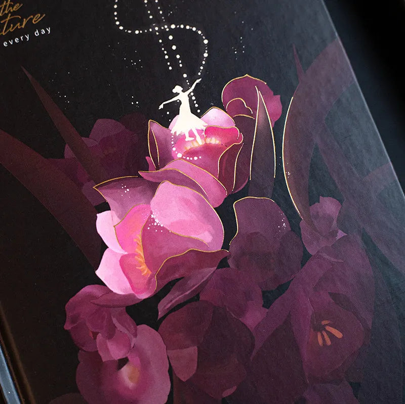 A5 notebook with luminous cover and silver foiling, open to show pages with colour illustrations.