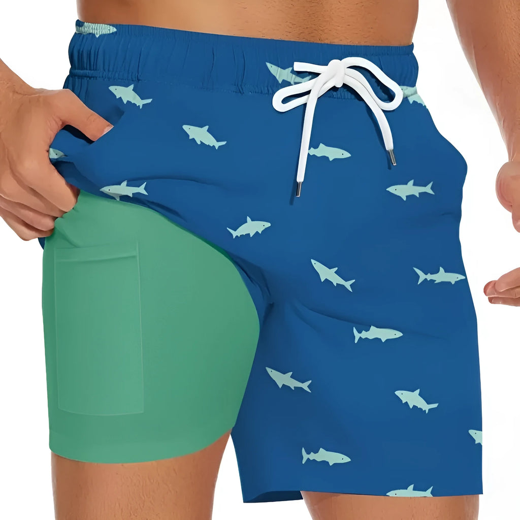 Men's black beach shorts with a white shark graphic print and a white drawstring waistband.