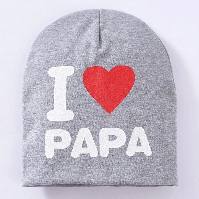 Baby hat in grey with 'Love Mama' text print, showing soft cotton-Lycra knit fabric