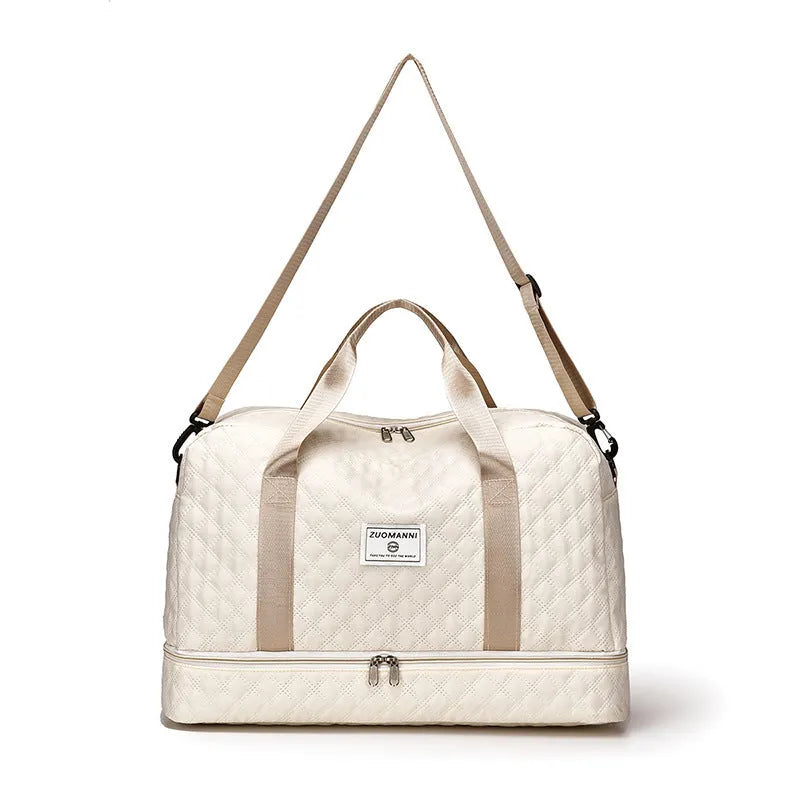 Large oxford cloth travel bag in a solid colour with visible sewing thread details, shown with the main compartment open.