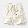 Man wearing khaki retro-style straight-leg cargo shorts made from polyester for summer streetwear.