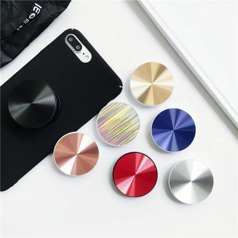 Ring phone stand in silicone and metal acting as a grip and stand for a mobile phone