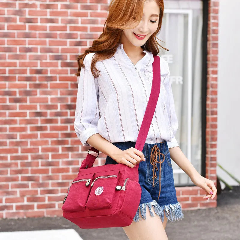 Nylon shoulder crossbody bag in casual style, available in multiple colours like black and red.