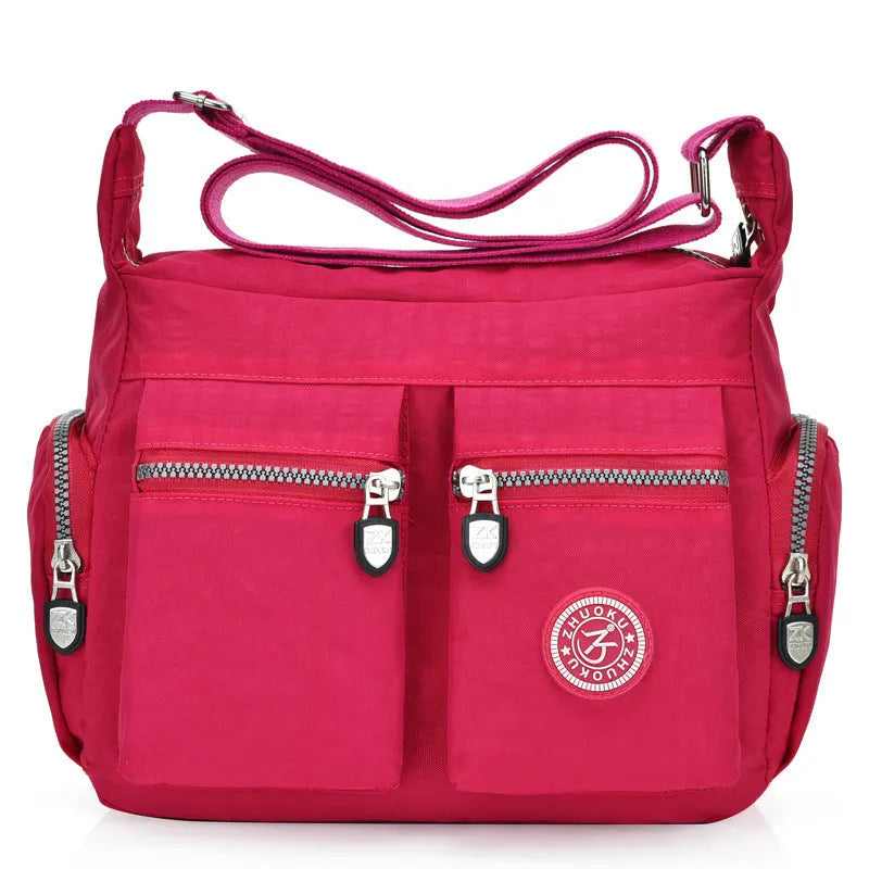 Nylon shoulder crossbody bag in casual style, available in multiple colours like black and red.