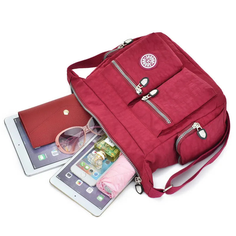 Nylon shoulder crossbody bag in casual style, available in multiple colours like black and red.
