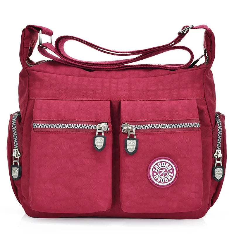 Nylon shoulder crossbody bag in casual style, available in multiple colours like black and red.